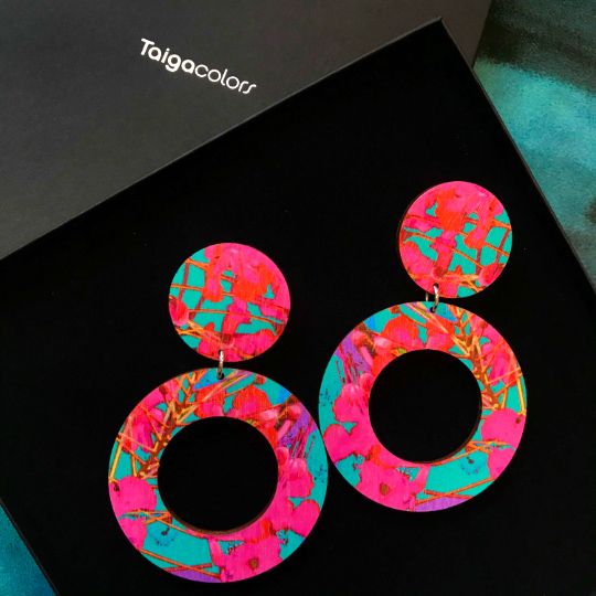 Hoop earrings with pink flowers on a turquoise background