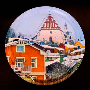 A tray with old houses in the front and Porvoo Cathedral on the background