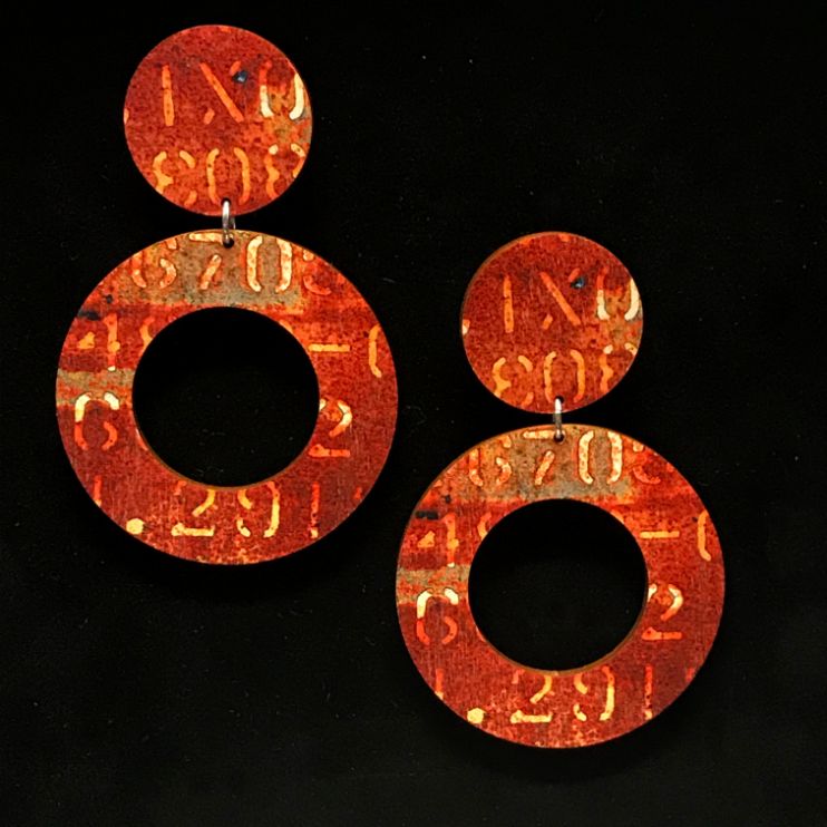 Burnt orange and brown hoop earrings with yellow numbers and letters