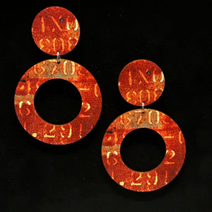 Burnt orange and brown hoop earrings with yellow numbers and letters