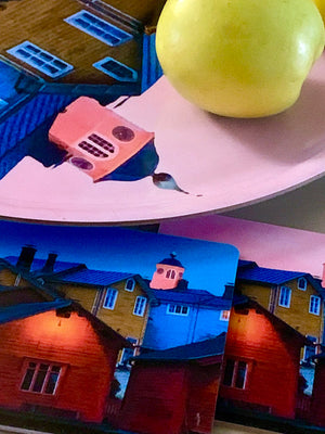 A green apple on a tray with Porvoo old houses